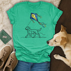 Green t-shirt with sketch of a dog running with a kite.