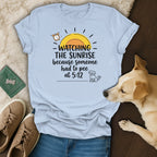 Light blue t-shirt with "Watching the sunrise because someone had to pee at 5:12" text and dog graphic.