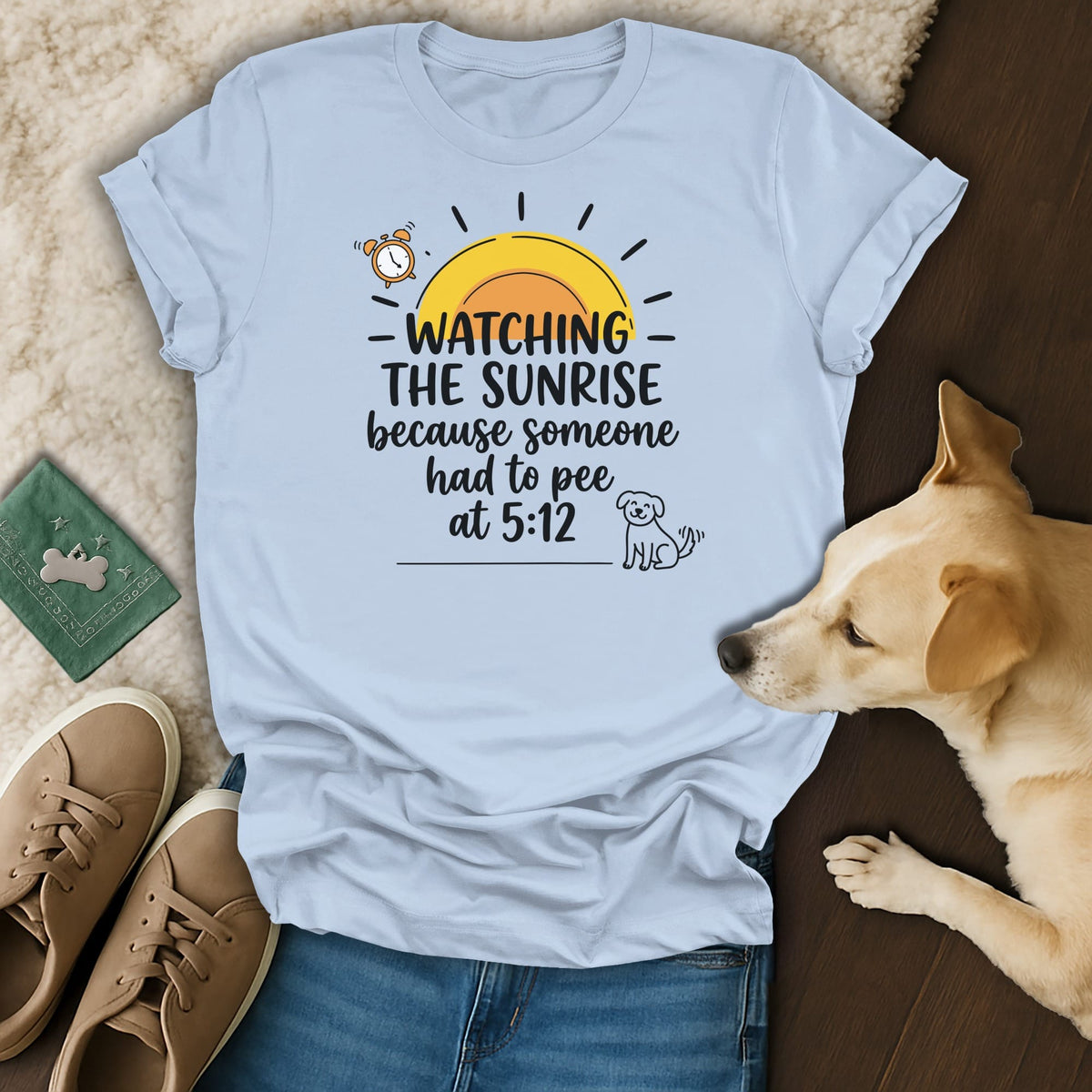 Light blue t-shirt with "Watching the sunrise because someone had to pee at 5:12" text and dog graphic.