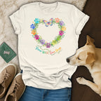 T-shirt with colorful paw print heart wreath and "Grow Wild, Love Dogs" text.