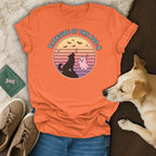 Orange t-shirt with a circular graphic of a howling wolf and ghost, reading "Barkside of the Boo-n".