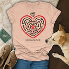 Light pink t-shirt with a heart maze graphic. "START" and "EVERY PAW LEADS TO LOVE".
