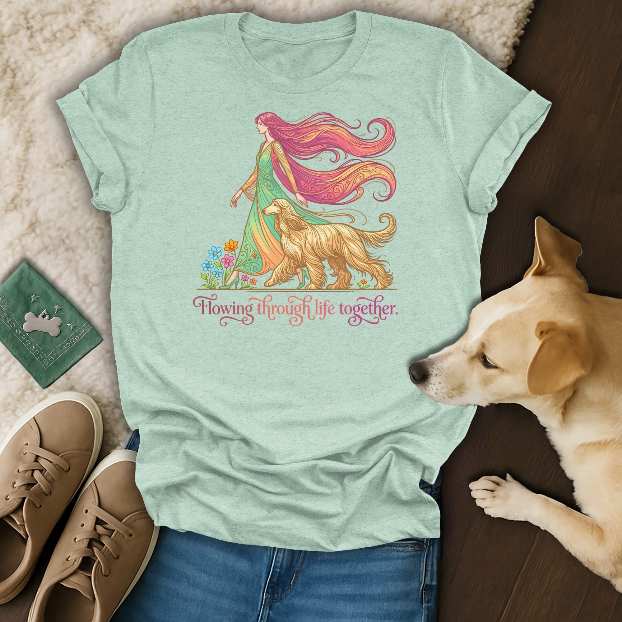 Mint t-shirt with woman and dog illustration, surrounded by flowers.