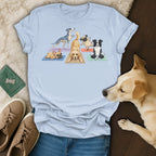 Light blue t-shirt with dogs doing yoga in cartoon style.