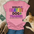 Pink t-shirt with "World's Okayest Dog Trainer" text and a dog.
