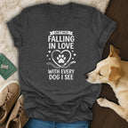 Dark grey t-shirt with white text: "Can't help falling in love with every dog I see."
