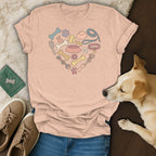 Peach t-shirt with heart design of dog toys, bones, and paws.