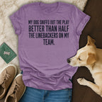 Purple t-shirt with text: "MY DOG SNIFFS OUT THE PLAY BETTER THAN HALF THE LINEBACKERS ON MY TEAM."