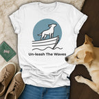 White t-shirt with dog on boat graphic and "Un-leash The Waves" text.