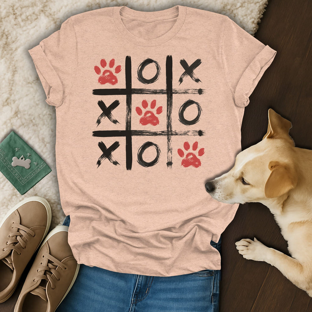 Peach t-shirt with a tic-tac-toe grid featuring paw prints and X's and O's.