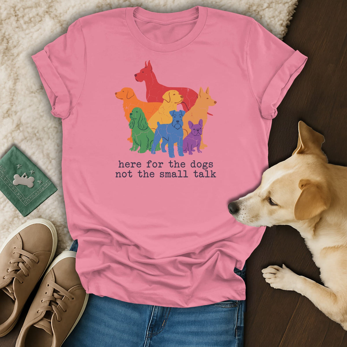 Pink t-shirt with a graphic of rainbow dogs and text "here for the dogs not the small talk".