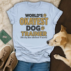 World's Okayest Dog Trainer shirt with dog paw prints and text.