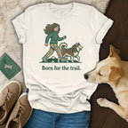Cream t-shirt with graphic of woman and husky dog with text "Born for the trail."
