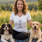 Woman in white t-shirt with dog graphic and text "AGAIN." with two dogs.
