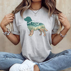 Grey t-shirt with a dog silhouette filled with ocean waves, shells, and seaweed.