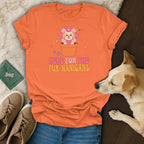 Orange t-shirt with a cartoon Shih Tzu in a flower and text "HERE FOR THE FUR-NANIGANS".