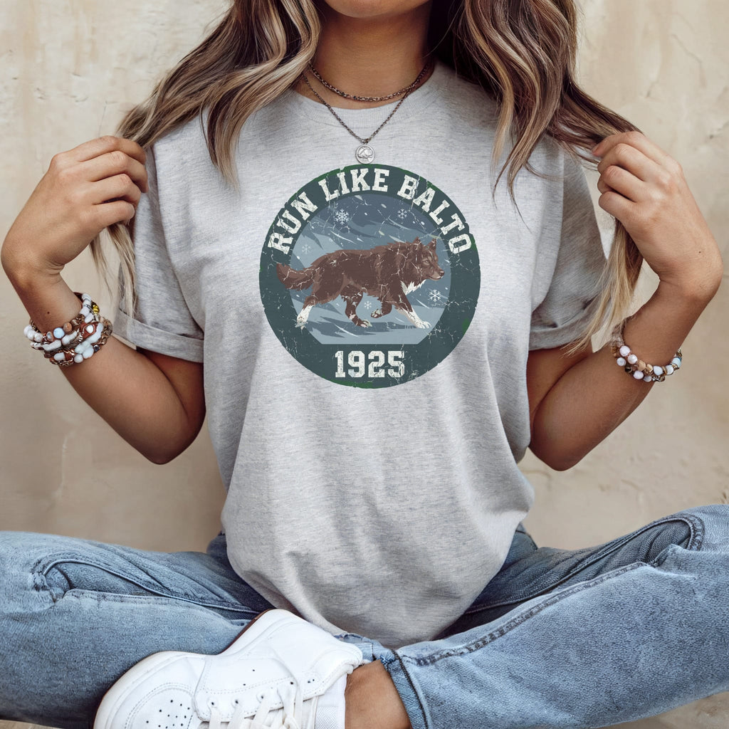 Gray t-shirt with "Run Like Balto 1925" text and a wolf graphic.