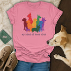 Pink t-shirt with colorful dog silhouettes and "my kind of book club" text.