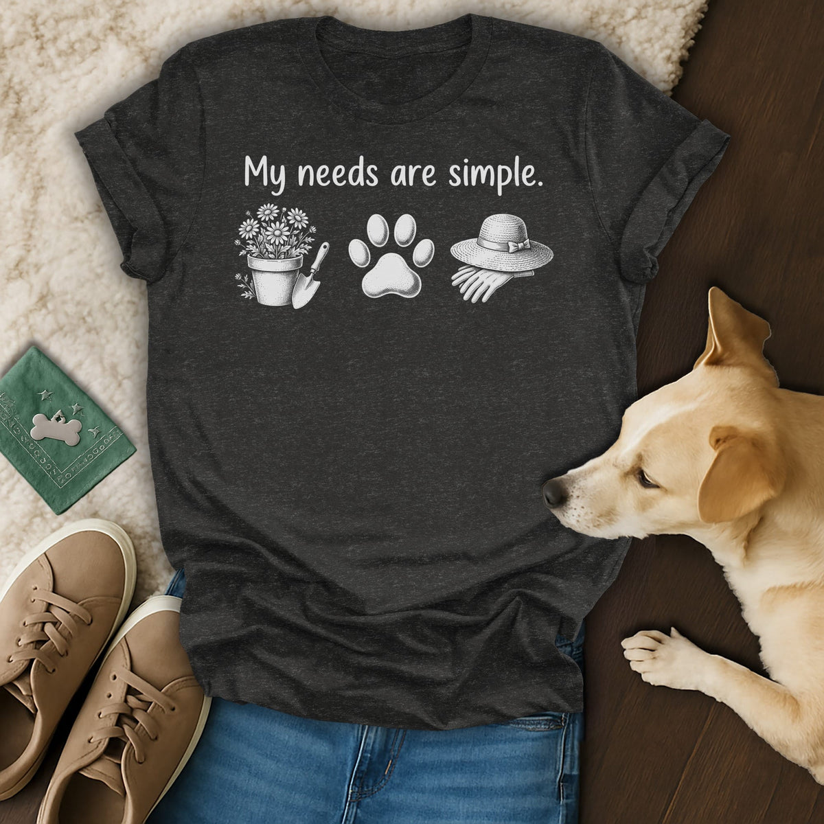 Dark grey t-shirt with "My needs are simple." text and gardening, paw print, and hat icons.