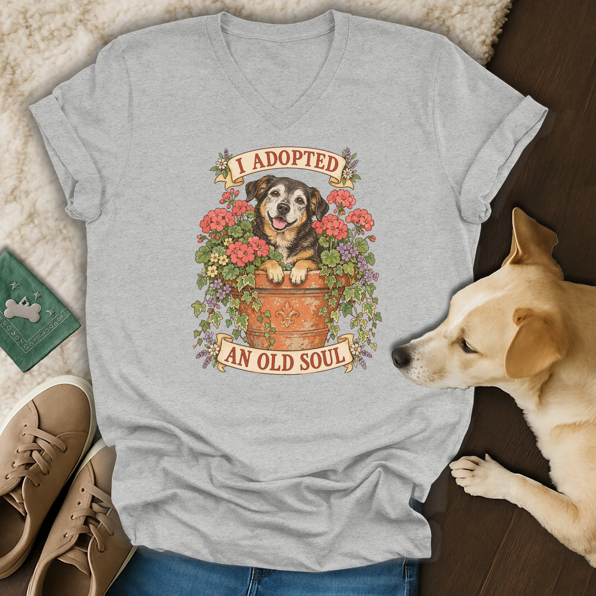A heather gray v-neck t-shirt featuring a floral pot graphic with the text "I ADOPTED AN OLD SOUL."