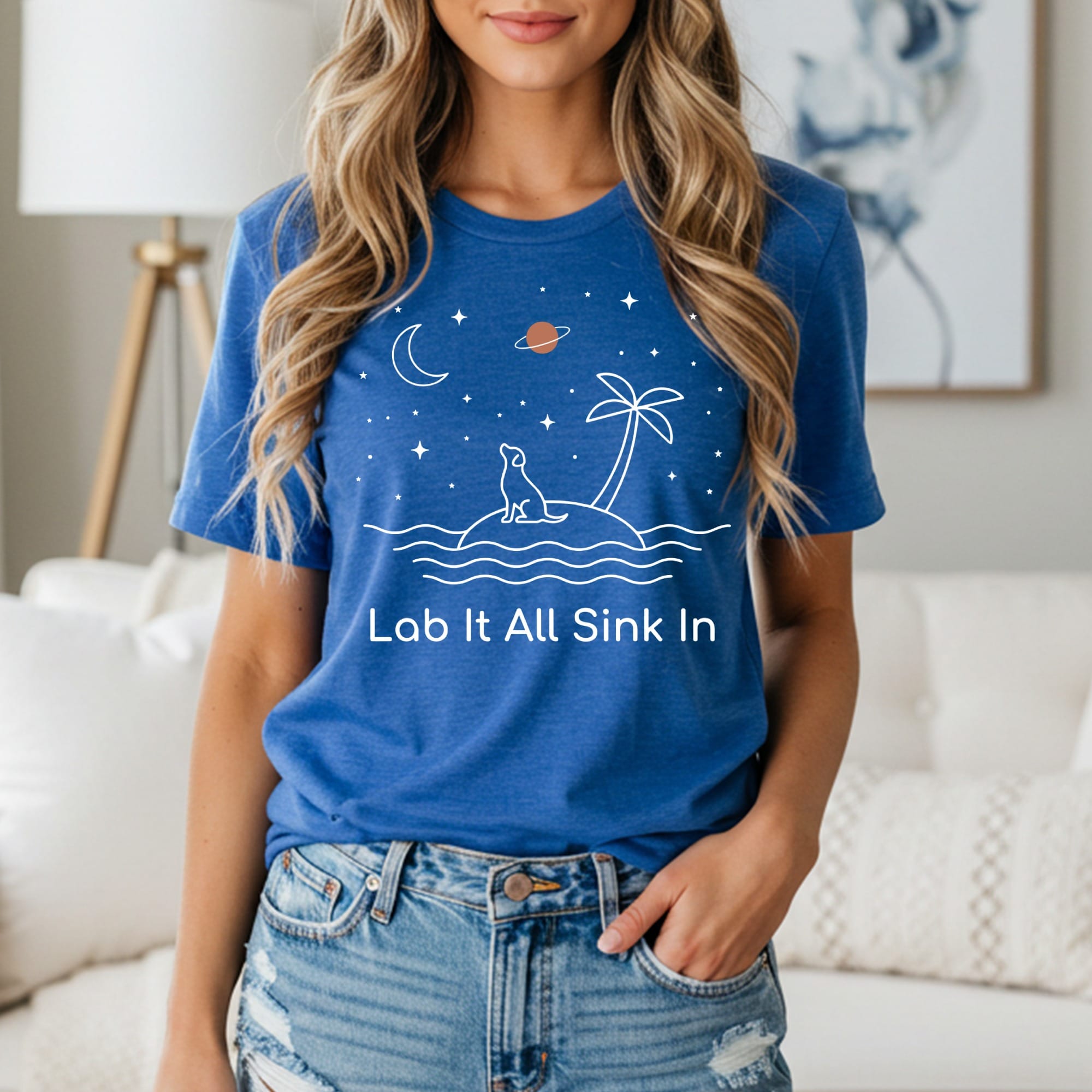 Blue t-shirt with "Lab It All Sink In" text and dog on island graphic.