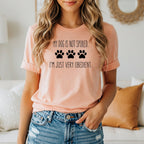 Peach t-shirt with black text and paw prints: "My dog is not spoiled. I'm just very obedient."