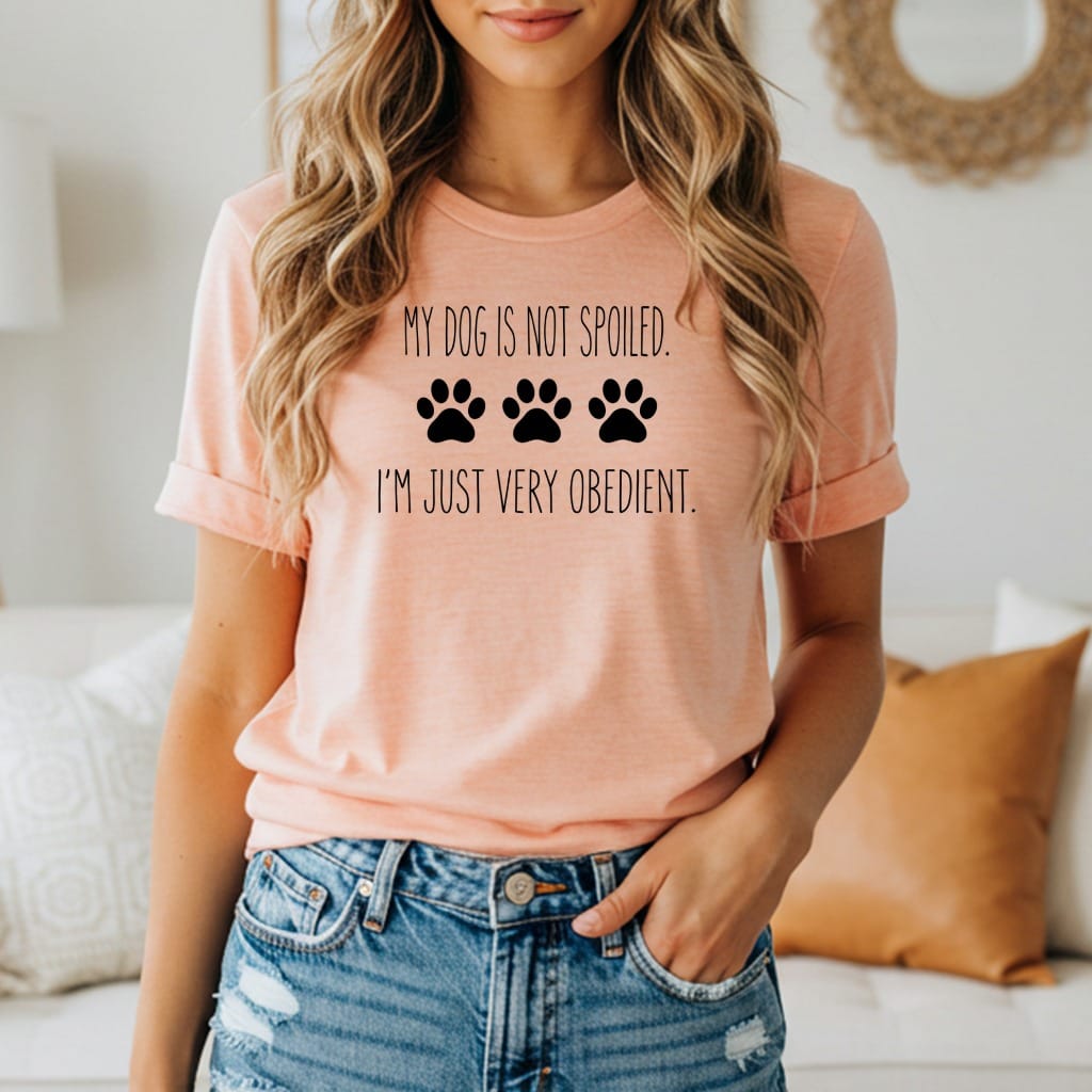 Peach t-shirt with black text and paw prints: "My dog is not spoiled. I'm just very obedient."