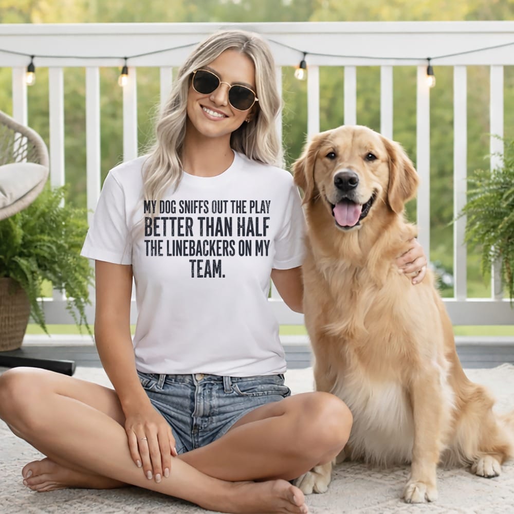 Woman in white t-shirt with dog, text reads "My dog sniffs out the play better than half the linebackers on my team."