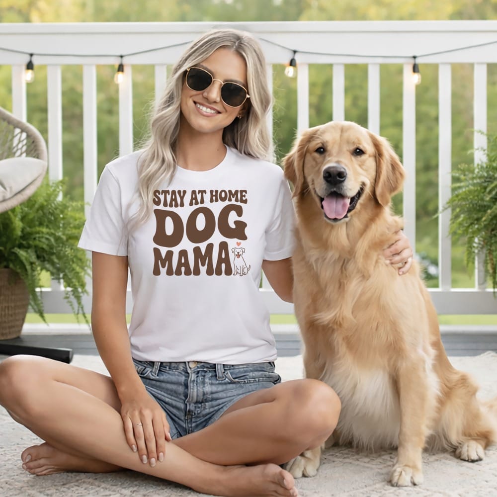 Woman and golden retriever on porch, wearing white t-shirt with "Dog Mama" text.