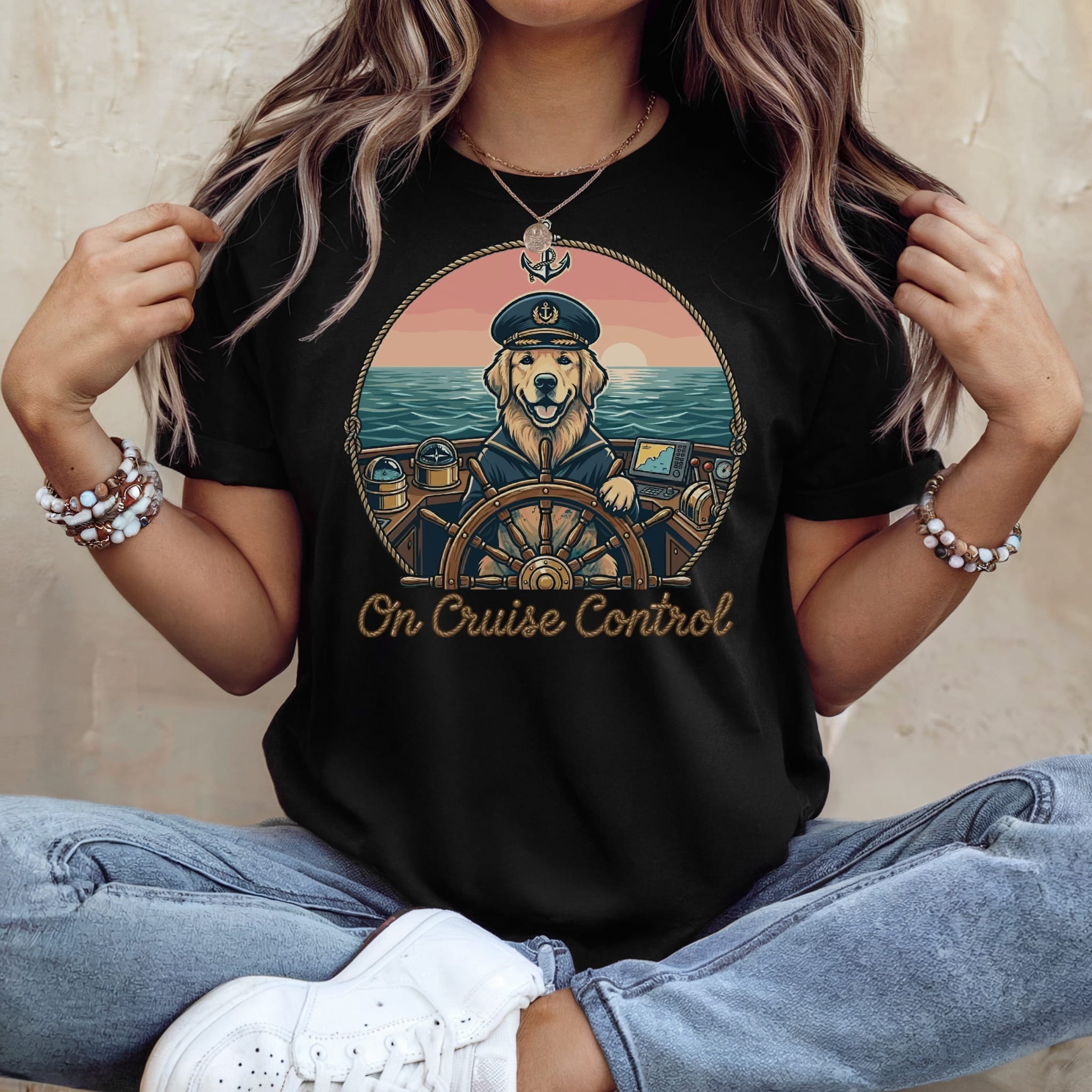 Black t-shirt with a cartoon dog captain steering a boat, sunset scene, "On Cruise Control" text.