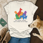 Cream t-shirt with colorful dog illustration and "but first, coffee and a whole lot of dogs" text.