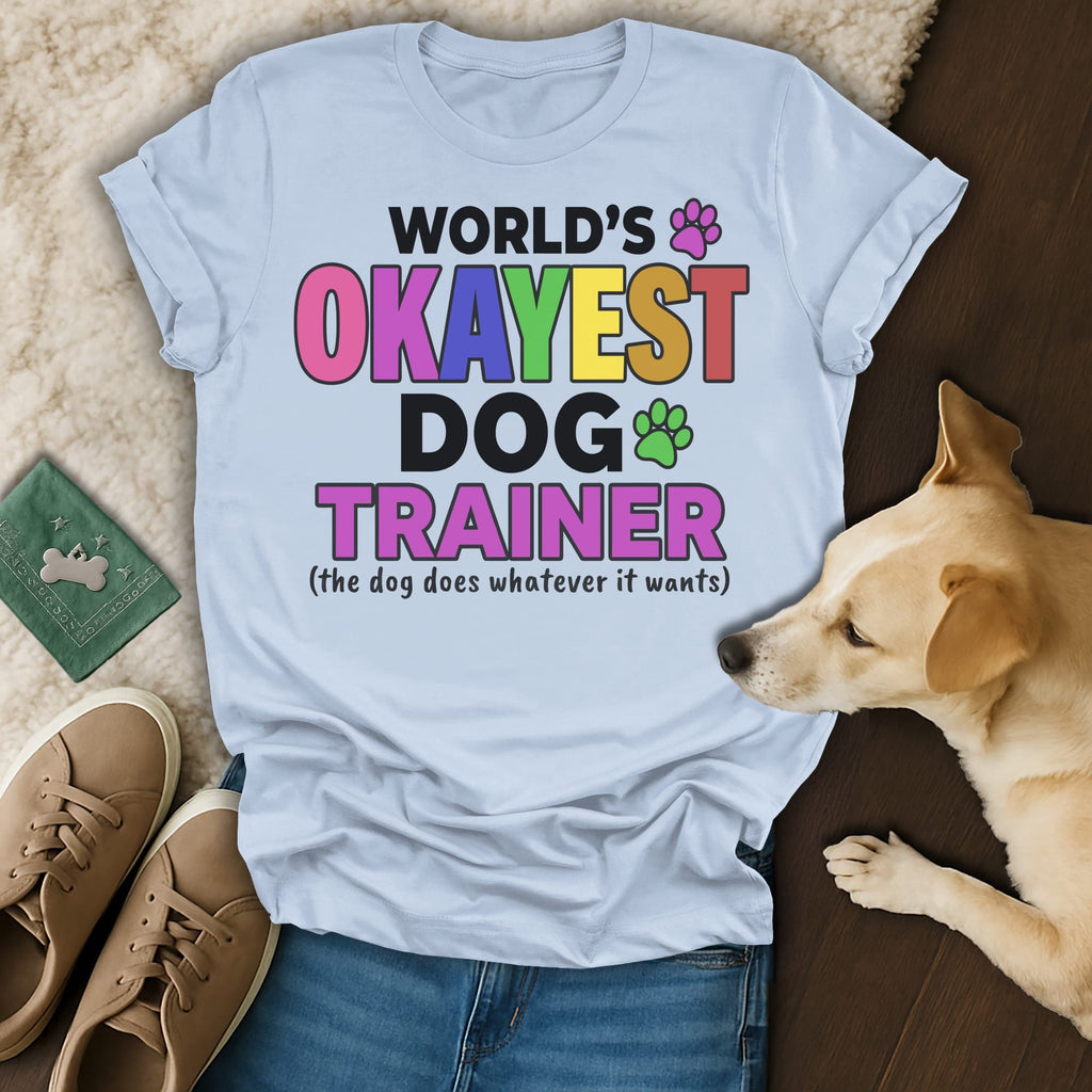 Light blue t-shirt with "World's Okayest Dog Trainer" text.