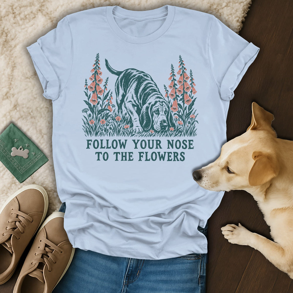 Light blue t-shirt featuring a dog sniffing flowers illustration with the text Follow Your Nose to the Flowers.
