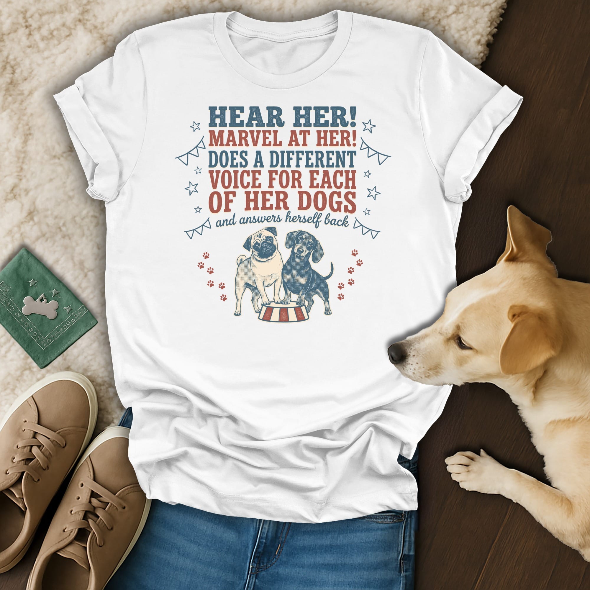 White t-shirt with "Hear Her! Marvel At Her! Does a Different Voice For Each Of Her Dogs" and pug/dachshund graphic.
