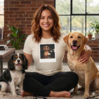 Woman in t-shirt with dog graphic sits with two dogs, a labrador and a cavalier.
