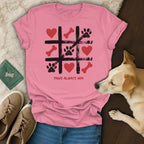 Pink t-shirt with a tic-tac-toe pattern of paw prints, bones, and hearts.
