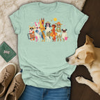T-shirt with cartoon dogs in beach attire, sunglasses and sun hat, carrying beach items.