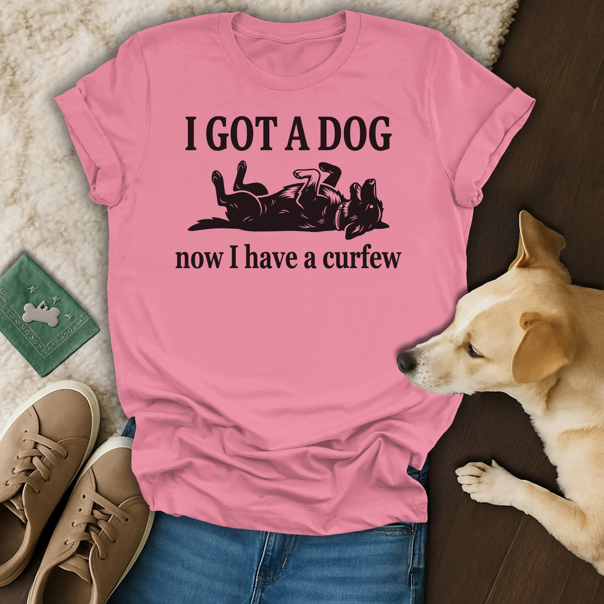 Pink t-shirt with black text "I GOT A DOG now I have a curfew" and dog graphic.
