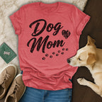 Red t-shirt with "Dog Mom" text and paw prints, with dog and shoes.