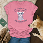 Pink t-shirt with illustration of a dog wearing sunglasses and a sweater, with text.