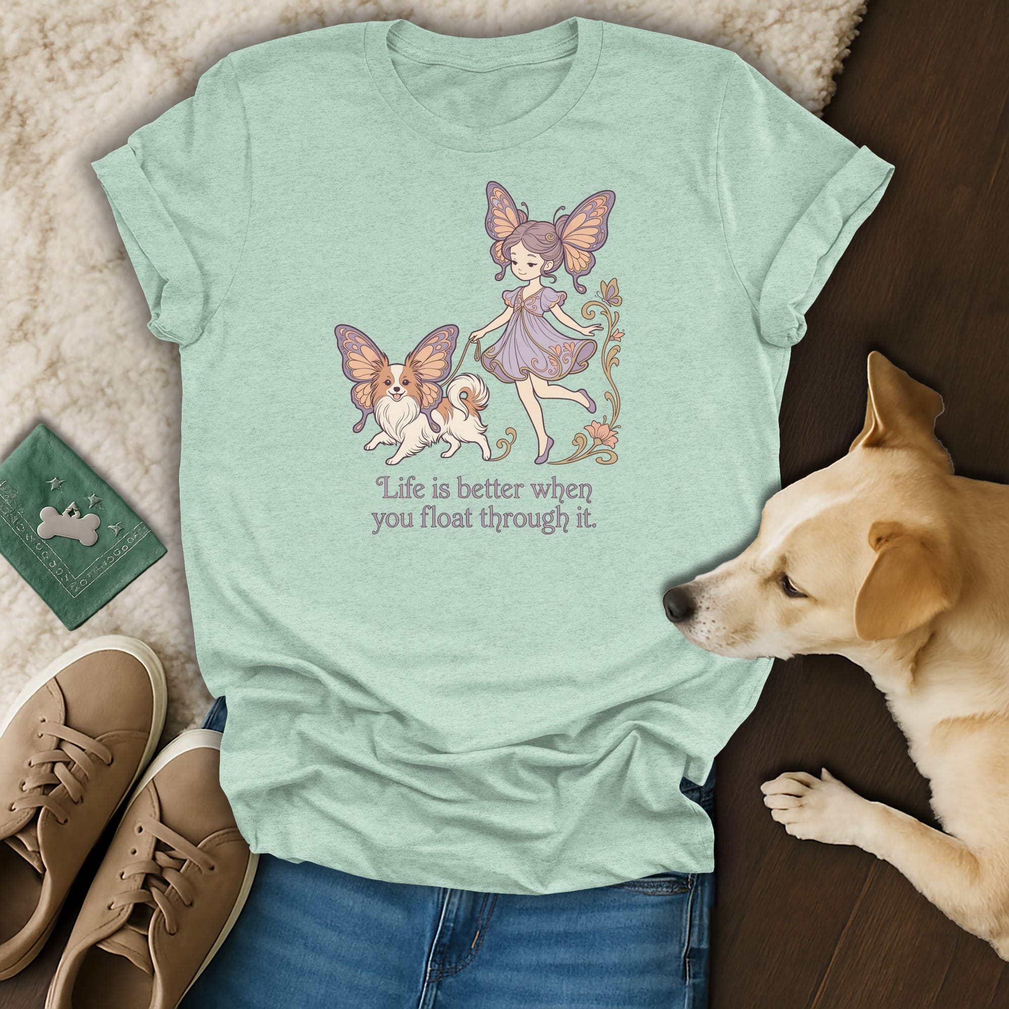 Light blue t-shirt with illustration of a girl and dog walking, "Life is better when you float through it."