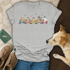 Cartoon dogs wearing helmets ride scooters in a line across a grey t-shirt.