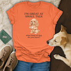 Orange t-shirt with "I'M GREAT AT SMALL TALK" and a dog holding a teacup.