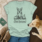 Light green t-shirt with a black sketch of a corgi and pumpkins, text "Feelin' Gourd-geous."