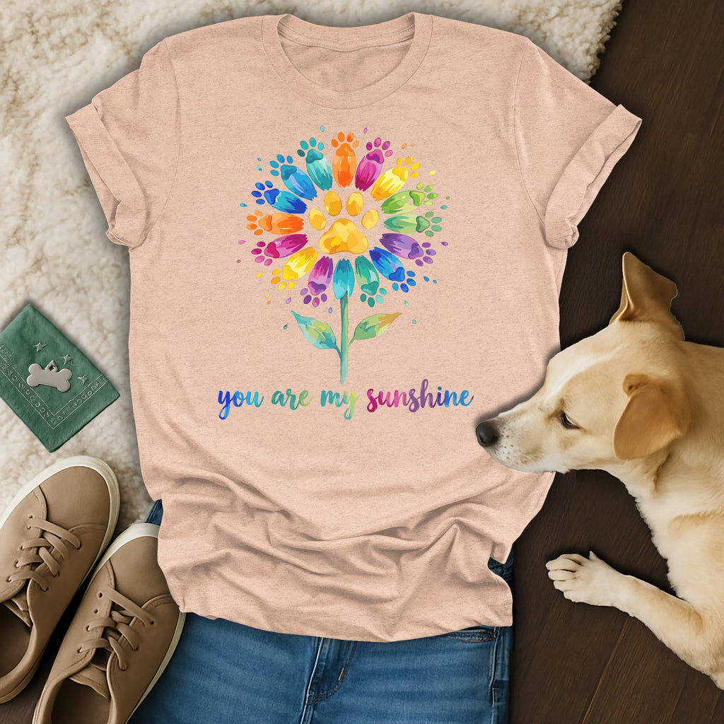Peach t-shirt with rainbow paw print flower and "you are my sunshine" text.