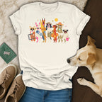 White t-shirt with colorful cartoon dogs ready for a beach vacation.