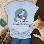 Light blue t-shirt with dog on a boat logo and "Un-leash The Waves" text.