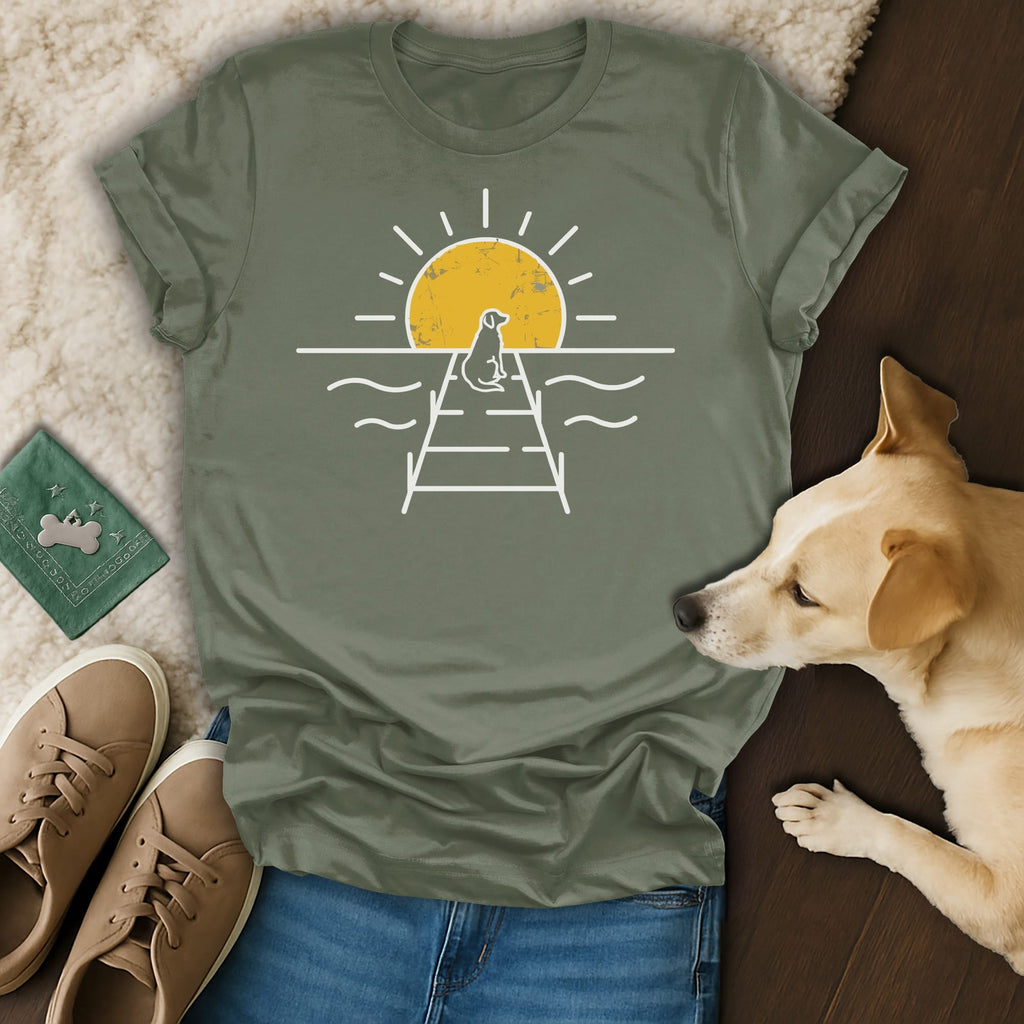 Dog on pier silhouette against a sunrise on a graphic t-shirt.