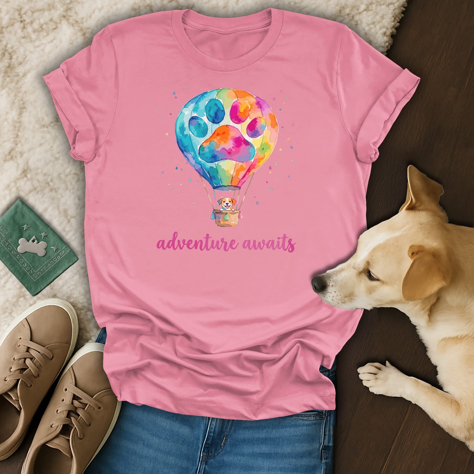 Pink t-shirt with watercolor hot air balloon paw print and "adventure awaits" text.