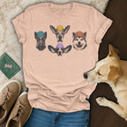 T-shirt with four dog heads wearing colorful beanies.